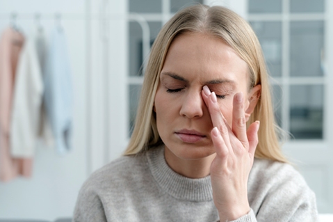 Woman with eye irritation from dry eye